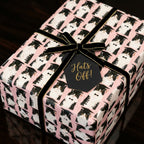 Pink cat graduation wrapping paper with a black velvet ribbon and "Hats Off" tag by Wrapped Studios.