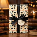 Congrats graduate wrapping paper with caps and black satin ribbon by Wrapped Studios.