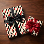 Graduation wrapping paper with red and black cap and gown pattern and satin bows by Wrapped Studios.