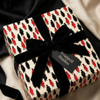 Graduation wrapping paper with red and black graduate print and black velvet bow by Wrapped Studios.