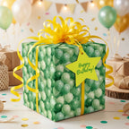 Green balloon birthday wrapping paper with a bright yellow bow, by Wrapped Studios.