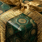 Emerald and gold luxury wrapping paper with a metallic fringe bow by Wrapped Studios.