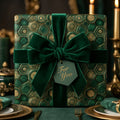 Luxury green and gold geometric Christmas wrapping paper with a velvet bow by Wrapped Studios.