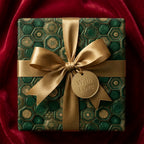 Luxury green and gold geometric wrapping paper with a gold ribbon on red velvet, by Wrapped Studios.