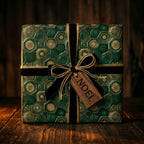 Luxury green and gold Christmas wrapping paper with velvet ribbon and Noel tag by Wrapped Studios.