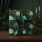 Elegant square gift wrapped in dark floral wrapping paper with emerald green ribbon and "A Timeless Gift" tag.
