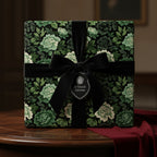 Elegant gift wrapped in dark floral wrapping paper with a velvet bow and "A Grand Gesture" tag.