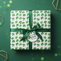 St. Patrick's Day gift with clover wrapping paper, emerald ribbon, and tag reading "A little luck for you."