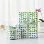 Two gifts wrapped in cloverleaf pattern paper with green striped ribbon.