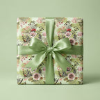 Sage green vintage floral wrapping paper with a satin ribbon bow on a gift box by Wrapped Studios.