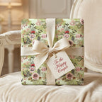 Sage green floral wedding wrapping paper with cream bow and 'Happy Couple' tag by Wrapped Studios.