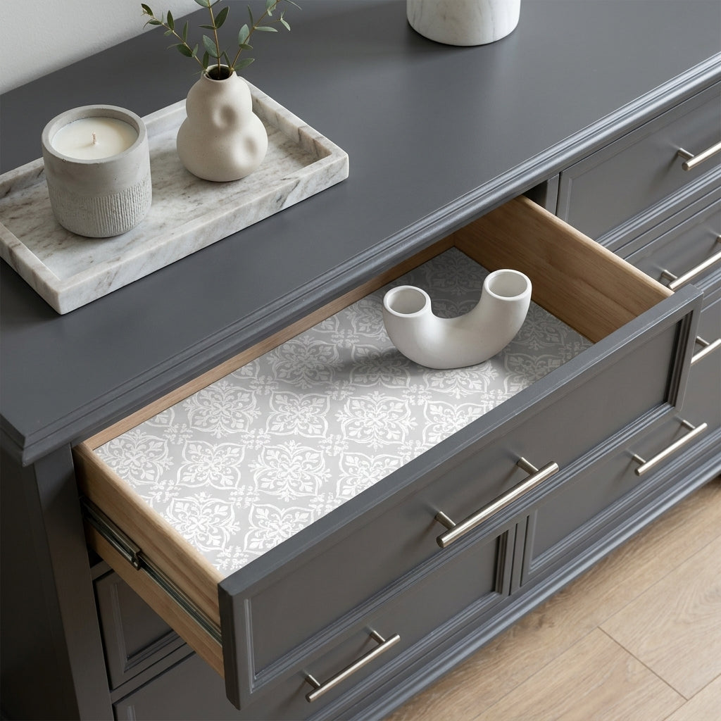 Grey damask wrapping paper used as a drawer liner in a grey dresser by Wrapped Studios.