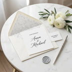 Elegant damask wedding wrapping paper and stationery by Wrapped Studios on a marble table.