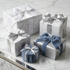 Elegant silver luxury gift wrap with damask patterns and blue velvet ribbons, by Wrapped Studios.