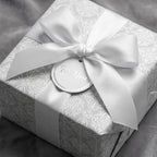 Elegant silver damask wrapping paper with white satin bow and 'For You' gift tag by Wrapped Studios.