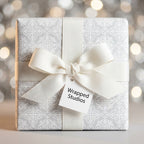 Elegant silver damask holiday wrapping paper with white ribbon bow, by Wrapped Studios.