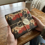 Rustic bear print wrapping paper by Wrapped Studios. Brown twine ribbon on a gift box.
