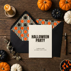 Halloween party invitation with orange polka dot envelope liner on rustic wood by Wrapped Studios.