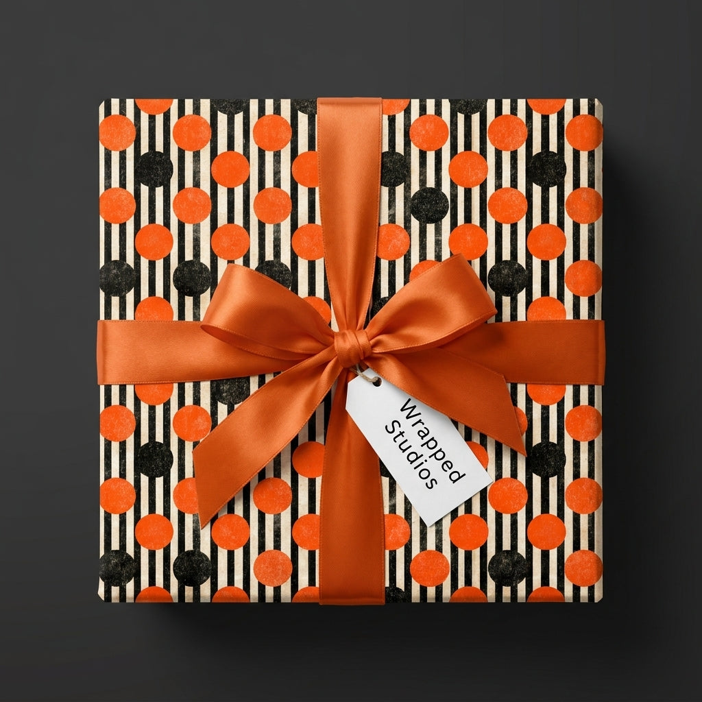 Orange and black Halloween wrapping paper with a polka dot pattern and satin ribbon, by Wrapped Studios.