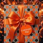 Orange polka dot and striped birthday wrapping paper with a large satin bow, by Wrapped Studios.