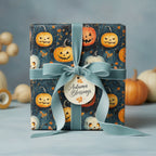 Square gift wrapped in Halloween pumpkin wrapping paper with a velvet ribbon and "Autumn Blessings" tag.