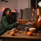 Friends exchanging a Halloween present wrapped in brown paper with orange jack-o-lanterns.