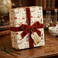 Vintage science wrapping paper with beaker pattern and rust velvet bow. Gift wrap by Wrapped Studios.