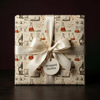 Science wrapping paper with vintage chemistry design and cream satin bow by Wrapped Studios.