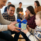 Hanukkah wrapping paper with blue Stars of David and green leaves by Wrapped Studios.