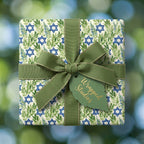 Botanical Star of David Hanukkah wrapping paper with a green ribbon bow by Wrapped Studios.