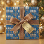 Luxury blue and gold menorah Hanukkah wrapping paper with a metallic bow by Wrapped Studios.