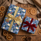 Blue Hanukkah wrapping paper with Stars of David and gold ribbons on holiday gifts by Wrapped Studios.