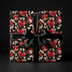 Gothic romantic wrapping paper with red hearts and a black satin bow on a gift box by Wrapped Studios.