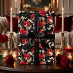 Luxury Valentine's wrapping paper with red hearts and a black ribbon, Wrapped Studios.