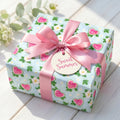 Cute watermelon wrapping paper with a pink satin bow on a summer gift box by Wrapped Studios.