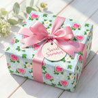 Cute watermelon wrapping paper with a pink satin bow on a summer gift box by Wrapped Studios.