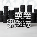 Gifts wrapped in hockey puck print wrapping paper with black and white ribbons for the hockey fan!