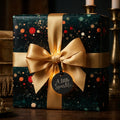 Luxury Christmas gift wrap with a gold satin bow on sparkly forest green paper by Wrapped Studios.