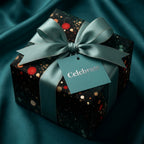 Luxury confetti wrapping paper with teal satin ribbon and a "Celebrate" tag by Wrapped Studios.