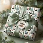 Watercolor dog Christmas wrapping paper with a sage green bow and pet tag by Wrapped Studios.