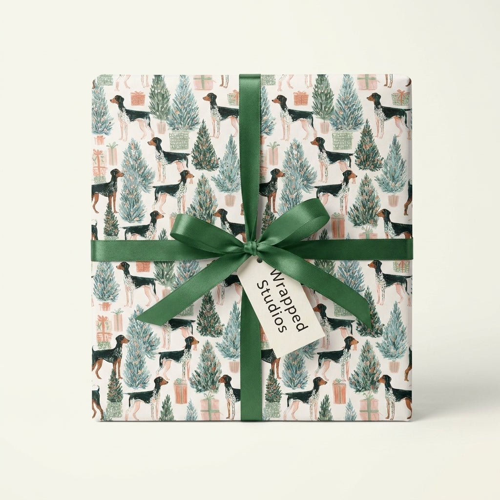 Dog Christmas wrapping paper with pointer dogs and trees, tied with a green ribbon by Wrapped Studios.
