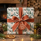 Dog Christmas wrapping paper with a rust orange bow and Santa Paws tag by Wrapped Studios.