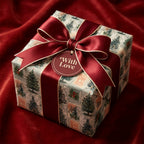 Vintage Christmas wrapping paper with luxury burgundy ribbon on a gift box, by Wrapped Studios.