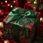 Elegant Christmas gift wrap featuring red floral pattern, emerald ribbon, and "With Love" tag.