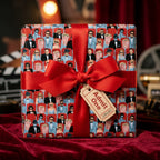 Retro cinema wrapping paper with a large red ribbon bow and movie ticket gift tag, by Wrapped Studios.