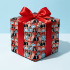 Retro movie theater wrapping paper with a red satin bow on a gift box by Wrapped Studios.