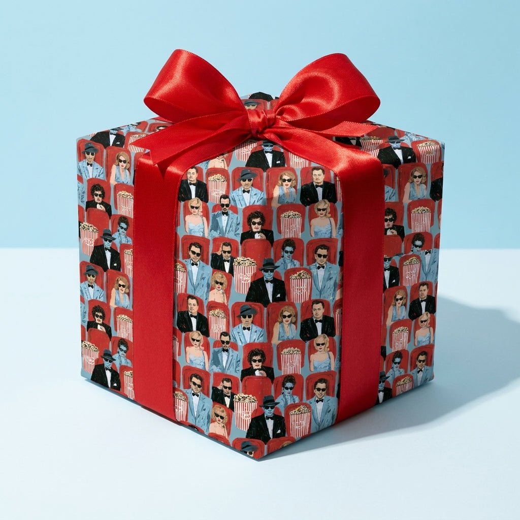 Retro movie theater wrapping paper with a red satin bow on a gift box by Wrapped Studios.