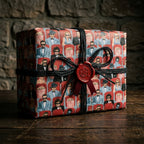 Vintage movie theater wrapping paper by Wrapped Studios on a gift box with black twine and red wax seal.