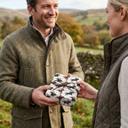 Equestrian horse wrapping paper on a rustic gift being exchanged outdoors, by Wrapped Studios.