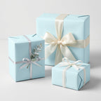Three square gifts wrapped in light blue paper with ribbon accents for birthdays or baby showers.